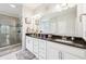 Elegant bathroom with double sink, granite counter, and glass shower at 9359 Foudray N Cir, Avon, IN 46123