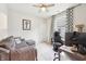 Cozy bedroom featuring a gray sectional couch, gaming chair, and a ceiling fan at 9359 Foudray N Cir, Avon, IN 46123