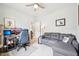 Cozy bedroom/office combo with gray sofa, gaming chair, desk and decor at 9359 Foudray N Cir, Avon, IN 46123