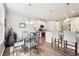 Bright dining area with a glass table set adjacent to a modern kitchen with white cabinetry at 9359 Foudray N Cir, Avon, IN 46123