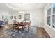 Bright dining room featuring a round wooden table, decorative rug, and ample natural light at 9359 Foudray N Cir, Avon, IN 46123