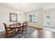 Dining room featuring a wooden table and chairs set, complemented by a modern chandelier at 9359 Foudray N Cir, Avon, IN 46123