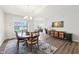 Open-concept dining room with wooden table set and a decorative painting on the adjacent wall at 9359 Foudray N Cir, Avon, IN 46123