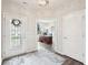 Welcoming foyer with decorative rug, glass door, and a view of the office at 9359 Foudray N Cir, Avon, IN 46123