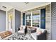 Inviting front porch with seating, decor, and a welcome mat entrance at 9359 Foudray N Cir, Avon, IN 46123