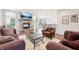 Open concept living room featuring a stone fireplace and bar seating area at 9359 Foudray N Cir, Avon, IN 46123