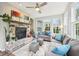 Cozy living room features a stone fireplace, bright windows, and comfortable seating, perfect for relaxing at 9359 Foudray N Cir, Avon, IN 46123