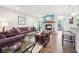 Cozy living room with stone fireplace, plush sofas, and wood flooring at 9359 Foudray N Cir, Avon, IN 46123