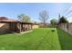 Expansive backyard showcasing the enclosed sunroom and well-maintained lawn at 9748 W Sunset Ln, Elwood, IN 46036