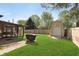 Backyard with a shed, grill, and an enclosed sunroom, perfect for outdoor enjoyment at 9748 W Sunset Ln, Elwood, IN 46036