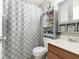 Cozy bathroom with decorative shower curtain and vanity with built in storage at 9748 W Sunset Ln, Elwood, IN 46036