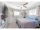 Bedroom featuring a ceiling fan, neutral walls, and natural light from the windows at 9748 W Sunset Ln, Elwood, IN 46036