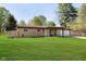 Beautiful one-story home boasting a well-maintained front yard, mature trees, and attached two-car garage at 9748 W Sunset Ln, Elwood, IN 46036
