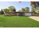 Charming ranch-style home featuring a spacious front yard, attached garage, and cozy front porch at 9748 W Sunset Ln, Elwood, IN 46036
