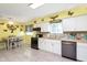 Bright kitchen showcasing butcher block countertops, white cabinetry, butterfly decor and an adjacent dining area at 9748 W Sunset Ln, Elwood, IN 46036