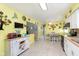 Inviting kitchen boasting white cabinets, butterfly decor, wood counters, and an adjacent dining area with natural light at 9748 W Sunset Ln, Elwood, IN 46036