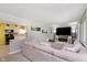 Inviting living room with a large sectional sofa, tv, and seamless flow into the adjacent kitchen area at 9748 W Sunset Ln, Elwood, IN 46036