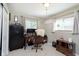 Office features two windows, a large desk, and built in shelving at 9748 W Sunset Ln, Elwood, IN 46036