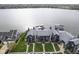 Aerial view of gray apartments by the water with boat docks, parking, and nearby clubhouse with pool at 102 Clarendon Dr # 506, Noblesville, IN 46062
