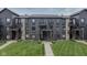 View of the exterior of a multi-Gathering building with stone accents and well-maintained landscaping at 102 Clarendon Dr # 506, Noblesville, IN 46062