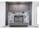 Close-up of stone fireplace with wood mantel. Ready for cozy evenings at 102 Clarendon Dr # 506, Noblesville, IN 46062