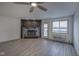 Cozy living room featuring a stone fireplace and large windows with water views at 102 Clarendon Dr # 506, Noblesville, IN 46062