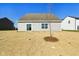 Backyard featuring the home's exterior with a sliding glass door and newly seeded yard at 10250 Camp Creek Way, Indianapolis, IN 46229