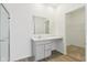 Bathroom with gray vanity, white countertop, a mirror, and walk-in closet at 10250 Camp Creek Way, Indianapolis, IN 46229