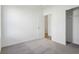 Bedroom showing a closet with sliding doors, neutral carpet, and a doorway to another room at 10250 Camp Creek Way, Indianapolis, IN 46229