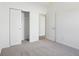 Bedroom showing a closet with sliding doors, neutral carpet, and a doorway to another room at 10250 Camp Creek Way, Indianapolis, IN 46229