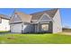 Charming two-story home with grey siding, a two-car garage, and freshly planted green lawn at 10250 Camp Creek Way, Indianapolis, IN 46229