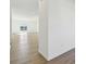 Hallway with hardwood floors that leads to a bright living space with view of pond in the background at 10250 Camp Creek Way, Indianapolis, IN 46229