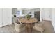 Modern eat-in kitchen boasts stainless steel appliances, gray cabinets and a dining table with seating at 10250 Camp Creek Way, Indianapolis, IN 46229