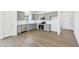 Stylish kitchen with stainless steel appliances, gray cabinets, and a view of an open dining space at 10250 Camp Creek Way, Indianapolis, IN 46229