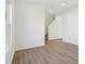 Bright room featuring light wood floors and stairs leading to the upper level at 10250 Camp Creek Way, Indianapolis, IN 46229