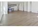 Open-concept living space with light wood floors, a kitchen, and ample natural light at 10250 Camp Creek Way, Indianapolis, IN 46229
