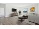 Bright living room featuring hardwood floors, neutral decor and sliding glass doors with water view at 10250 Camp Creek Way, Indianapolis, IN 46229
