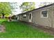 Back exterior featuring grassy yard, patio, and neutral colored vinyl siding at 112 Coronado Rd, Indianapolis, IN 46234