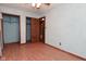 Bedroom with blue walls, wood-look flooring, closet and door at 112 Coronado Rd, Indianapolis, IN 46234