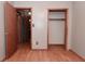 Bedroom with wood-look laminate flooring and closet with open shelving at 112 Coronado Rd, Indianapolis, IN 46234