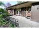 Inviting front porch of a single-story home with wood door at 112 Coronado Rd, Indianapolis, IN 46234