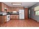 View of the kitchen area with light wood cabinets and white appliances at 112 Coronado Rd, Indianapolis, IN 46234