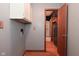 Laundry room with hardwood floors, grey walls, white cabinets, and electrical outlets at 112 Coronado Rd, Indianapolis, IN 46234