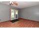 Living room with wood-look floors, gray walls, and a glass french door leading to the outside at 112 Coronado Rd, Indianapolis, IN 46234