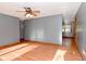 Spacious living room with laminate wood flooring, a ceiling fan, and natural light at 112 Coronado Rd, Indianapolis, IN 46234