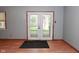 Living room featuring wood-look floors, gray walls, and a decorative glass double door at 112 Coronado Rd, Indianapolis, IN 46234