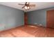 View of a gray-painted living room with new wood grain floors and a ceiling fan at 112 Coronado Rd, Indianapolis, IN 46234