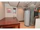 Basement utility area featuring a hot water tank next to a laundry area at 114 E 27Th St, Indianapolis, IN 46205
