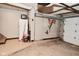 Unfinished basement showing concrete floor, storage items, and an attached garage at 114 E 27Th St, Indianapolis, IN 46205