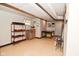 Finished basement space featuring shelving, a console table, and durable epoxy flooring at 114 E 27Th St, Indianapolis, IN 46205